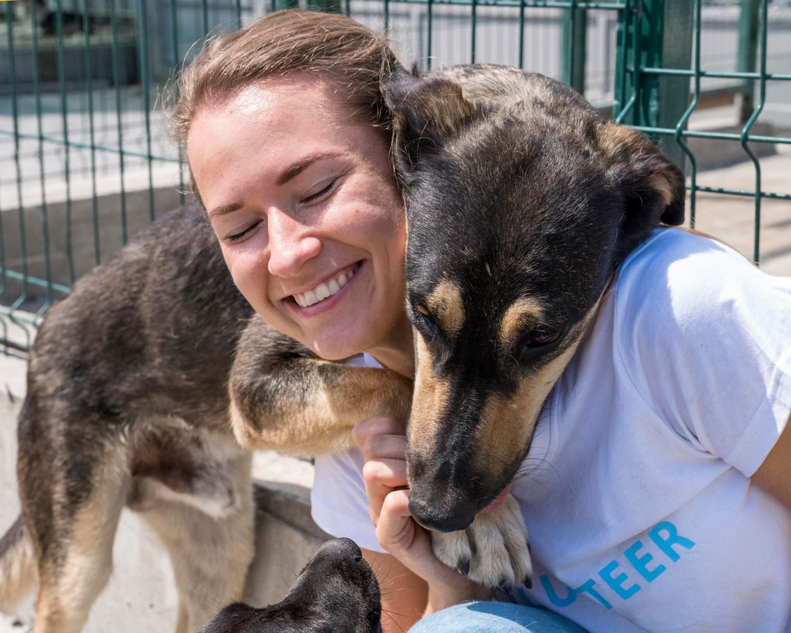 happy woman volunteering with rescue dog