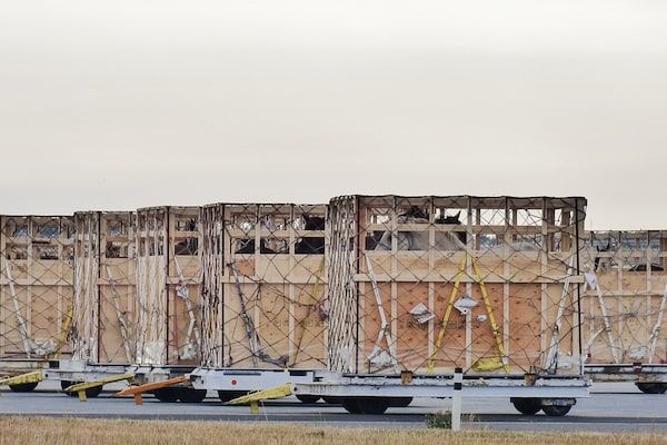 Horses in crates on the tarmac at Calgary International Airport